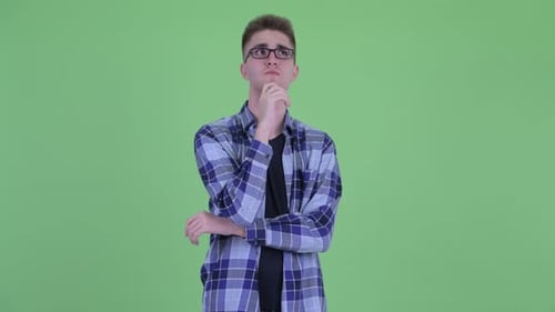 Young Man Thinking Against Green Screen Backdrop