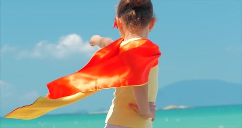 Girl Pretends to be Superhero on Tropical Beach