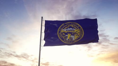 Nebraska State Flag Waving Dynamically Against a Sunset Sky