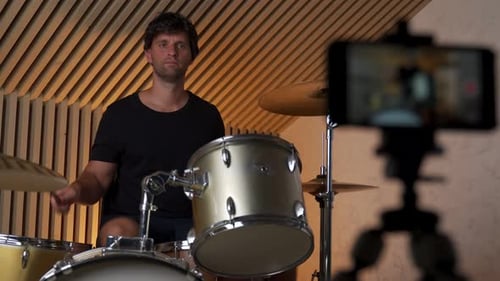 Musician Plays Drums While Recording with Phone