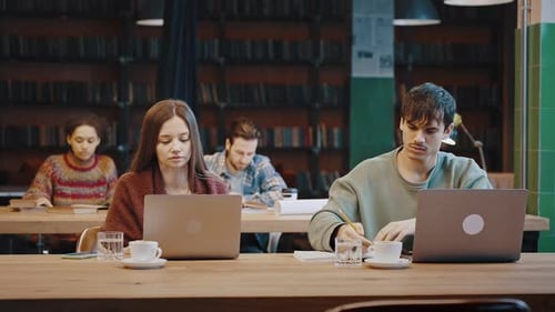 Multicultural Group of Serious Diverse Young People Studying in Library