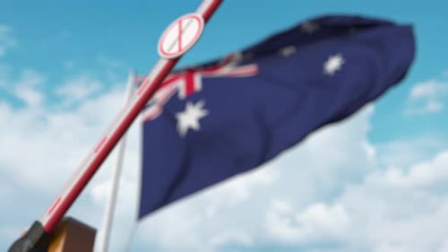 Australian Flag Behind Immigration Restriction Barrier with Stop Sign