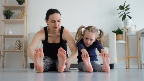 Mother and Child Exercising and Stretching at Home