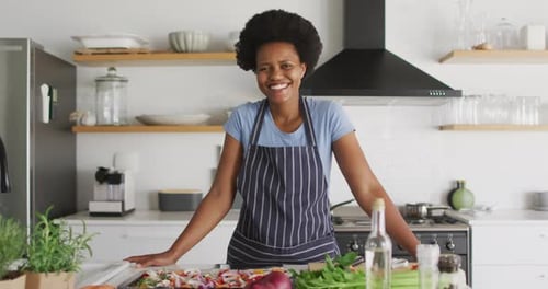 Smiling Woman with Vegetables in Modern Kitchen