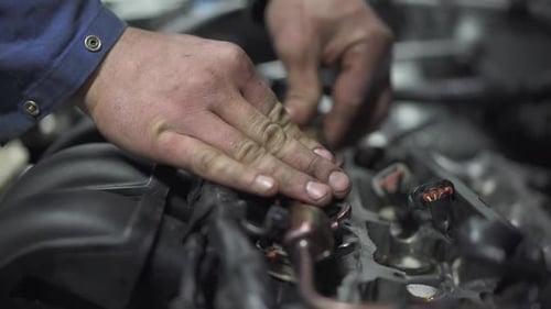 Mechanic Hands Working on a Car Engine
