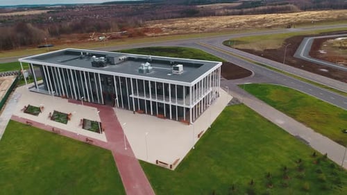 Stylish Building with Paved Ground Against Autumn Forest