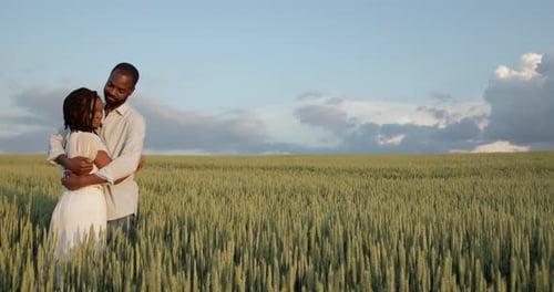 Happy Romantic Couple Hugging in a Summer Field