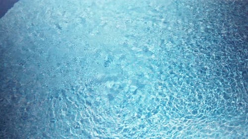 Pure Blue Water in Pool with Light Reflections