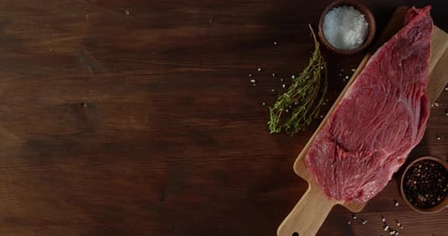 Raw Steak with Herbs and Spices on Board