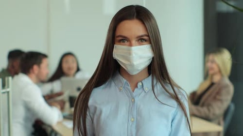 Woman in Mask Standing in Modern Office