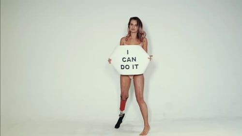 Confident Woman with Prosthetic Leg Holds Sign