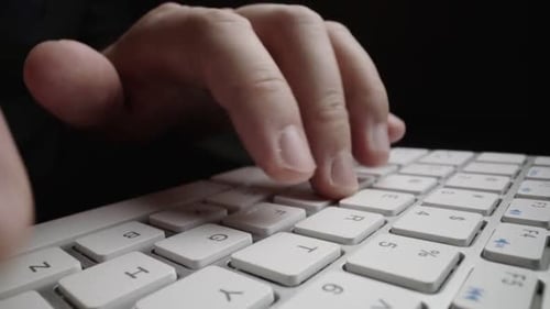 Closeup Typing on Keyboard with Man Fingers