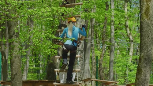 Climbing up the ladder in an adventure park