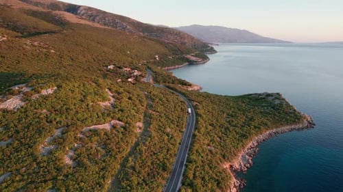 Aerial View Landscape Rocky Coast of Croatia with Curvy Mountain Road at Sunset
