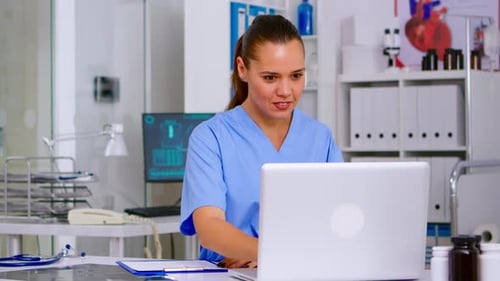 Medical Professional Working at Desk in Office