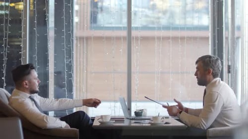 Two Businessmen on Business Meeting in Restaurant