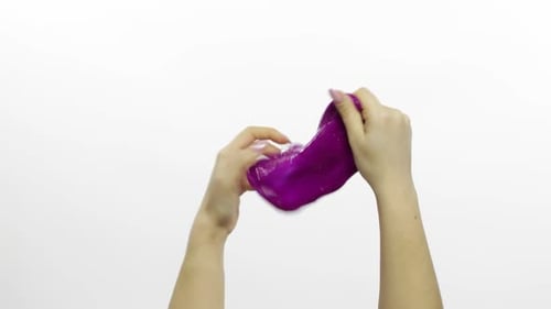 Woman Hands Playing Oddly Satisfying Purple Slime. White Background. Antistress