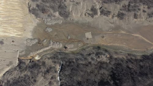 Drainage from the mine with pyrite on river coast 4K aerial video