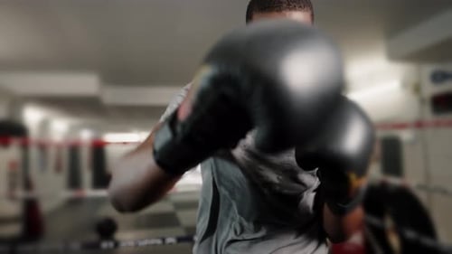 Young Athletic African Man Fighting on Ring at Gym While Preparing for Battle with Opponent