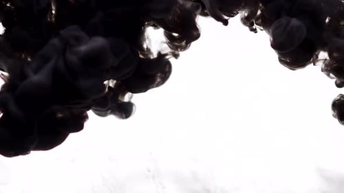 Black Fluid Pouring Into White Liquid Solution