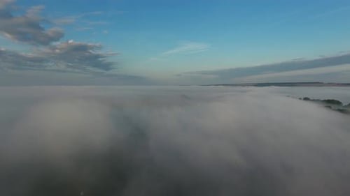 Aerial View of Fog Over Rolling Countryside