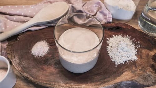 Baking Ingredients: Flour, Salt, and Starter on Wood