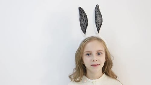 Adorable Girl Wearing Sequined Bunny Ears Indoors