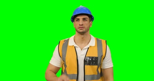 Architect in protective workwear using futuristic digital screen