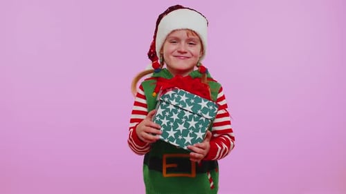 Crying Child Receiving Christmas Gift and Smiling