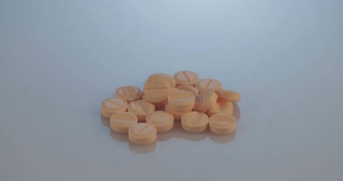 Rotating Group of Orange Medical Pills