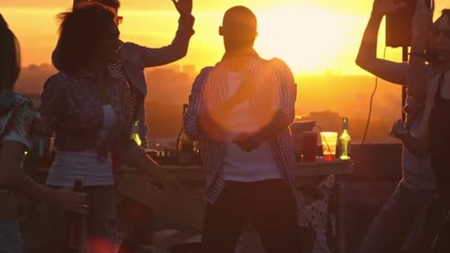 Friends Dancing at Sunset Rooftop Celebration