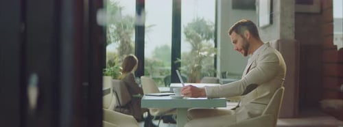 Businessman typing on laptop in cafe