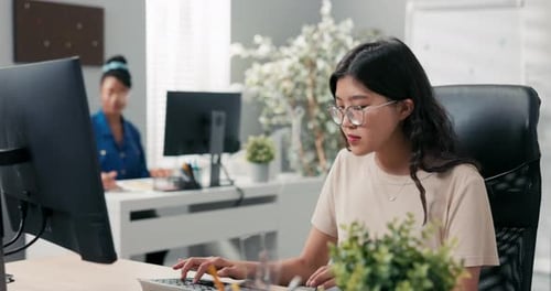Busy Afternoon at the Office Two Elegant Women Work in Front of the Company's Computers Clicking