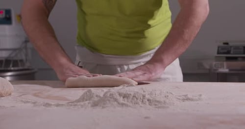 Slow Motion of Hands of Baker Chef Applying Flour on Dough