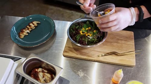 Gloved Chef Prepares Fresh Salad in Restaurant