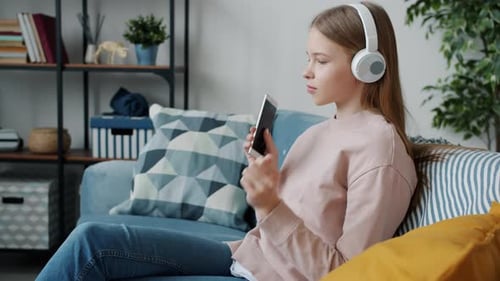 Teen Girl Listening to Music on Couch