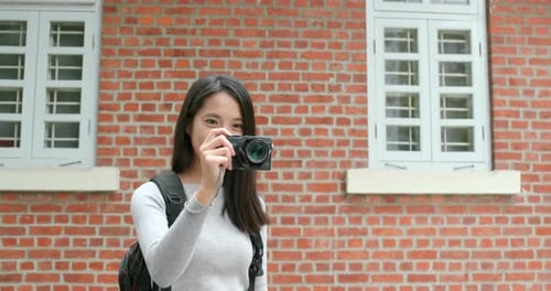 Woman Taking Photos on Vacation in City