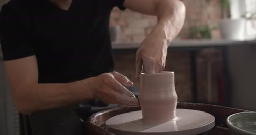 Potter Sculpts a Ceramics on a Potter's Wheel Video From Pottery Workshop Potter Makes Ceramics in