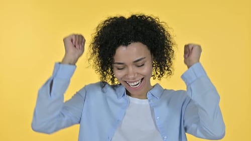Happy Woman Dancing Against Yellow Background