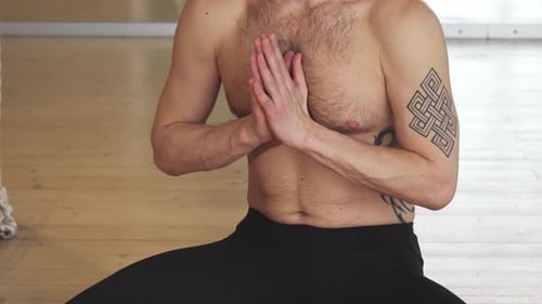 Man Meditating in Yoga Prayer Pose Indoors