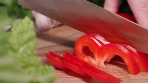 Cutting Red Pepper on Wood Cutting Board
