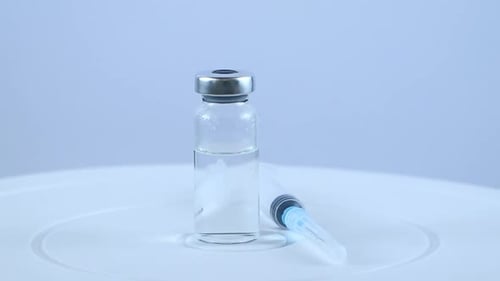 Injection Drug and Syringe on White Background