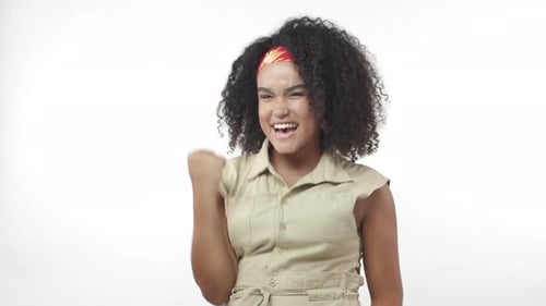 Cheerful Satisfied Africanamerican Female with Afro Haircut Do Fist Pump Move Cheering and