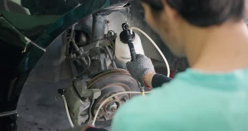 Car Brakes Adjusted by Auto Mechanic