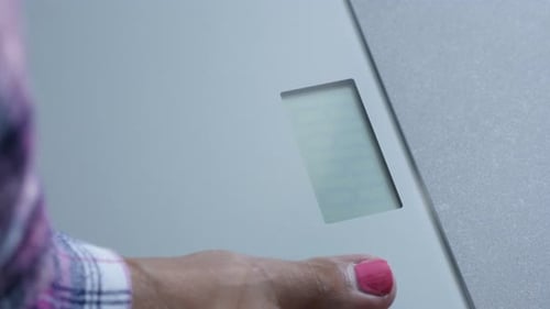 Morning weight measuring in female pajamas close-up 4K 2160p 30fps UHD footage - Digital health sca