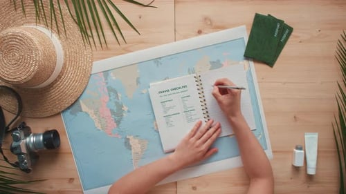Woman Writes Travel Checklist on World Map