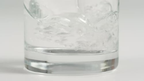 Water Being Poured into a Clear Glass