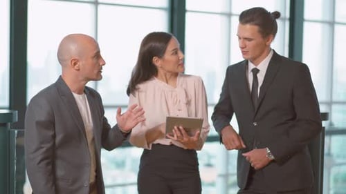 Business Team Discussing Tablet, Shaking Hands