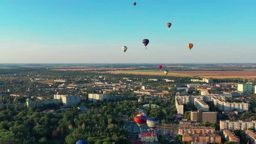 Hot Air Balloons Flying Over City