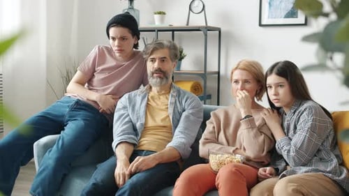 Family Watches Scary Movie on Couch Together